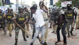 Police clash with a protester during demonstrations against the Citizenship Act in Mangaluru on December 19, 2019. |