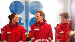 Red Cross medics waiting to check the temperature of participants at the OPEC+ meeting in Vienna, March 6, 2020 for coronavirus. None was found infected, but the meeting ended in disharmony.   