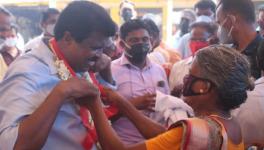 PP Chitharanjan being welcomed by a woman from the fishing community during the march.