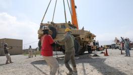 A Mine Resistant Ambush Protected vehicle being loaded on to a flatbed trailer, Bagram Air Field, Afghanistan. (File photo) 