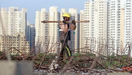 Labourers work at the Dwarka Expressway construction site