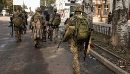 Ukrainian soldiers walk nonchalantly in Bakhmut city, a strategic hub, amidst Russia’s attacks, Donetsk, Oct. 2, 2022