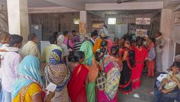 Family members of patients admitted at a hospital due to heatwave conditions, in Ballia, Sunday, June 18, 2023.