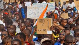 Protesters in Niger hold signs in support of the CNSP and against France