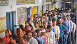 Voters wait in a queue at a polling station to cast their votes for the Madhya Pradesh Assembly elections, in Jabalpur, Friday, Nov. 17, 2023. 