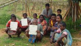 Forestland patta owners of Khemuya village, in West Bengal’s Bankura district, display their documents. The TMC and BJP tried to evict them two years ago.