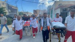 Palestinian Red Crescent crews mourn fellow paramedics Haitham Tubasi and Suhail Hassouna, killed by Israeli forced (Photo via PRCS)