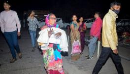 Jhansi hospital fire: A woman rushes a child to the emergency ward after a fire broke out in a neonatal intensive care unit at Jhansi Medical College hospital in Jhansi, India, Friday, Nov. 15, 2024.(AP)