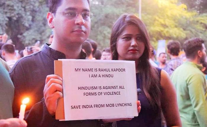 Participant holding a placard during the protest rally in Delhi.