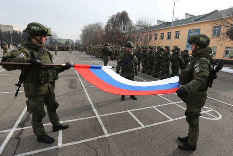 Russian servicemen fold the national flag during ceremony marking end of CSTO mission in Kazakhstan, Almaty, January 13, 2022