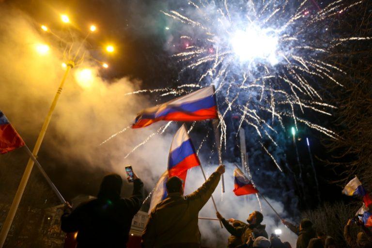 People wave Russian national flags celebrating Moscow’s recognition Donetsk and Lugansk, eastern Ukraine, Feb 21, 2022