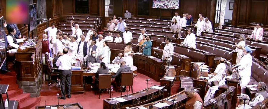 Opposition MPs shout slogans in the Well of Rajya Sabha while staging a protest over the price hike in fuel and essential commodities during the second part of the Budget Session of Parliament,