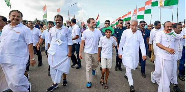 Congress leader Rahul Gandhi walks with a young supporter during party's 'Bharat Jodo Yatra' in Kerala. (Photo | PTI)