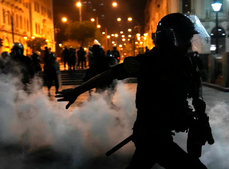 Police trying to break up supporters of ousted President Pedro Castillo at plaza San Martin in Lima, Peru, Sunday