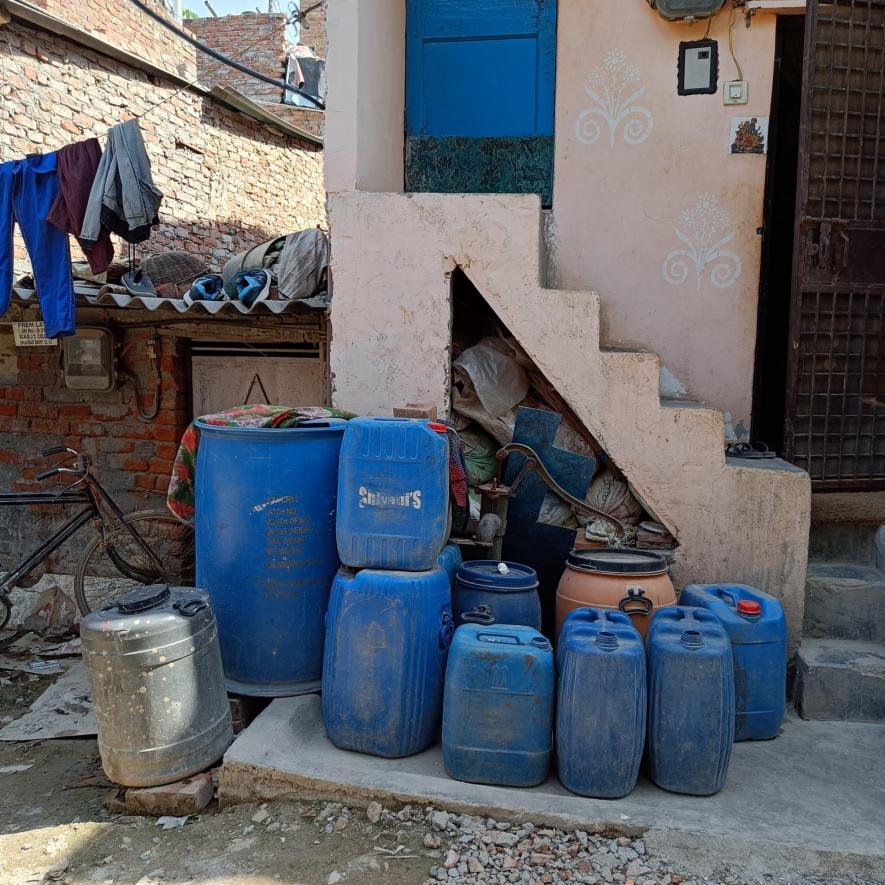 Cans lined up in the hope of filling up clean water.