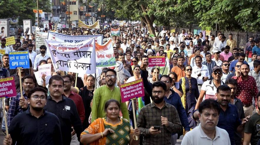 Government employees under the banners of Gujarat State Employees Mahamandal and Gujarat State United Employees Front participate in a protest march over various demands including restoration of the old pension scheme, in Rajkot, September 11, 2022.