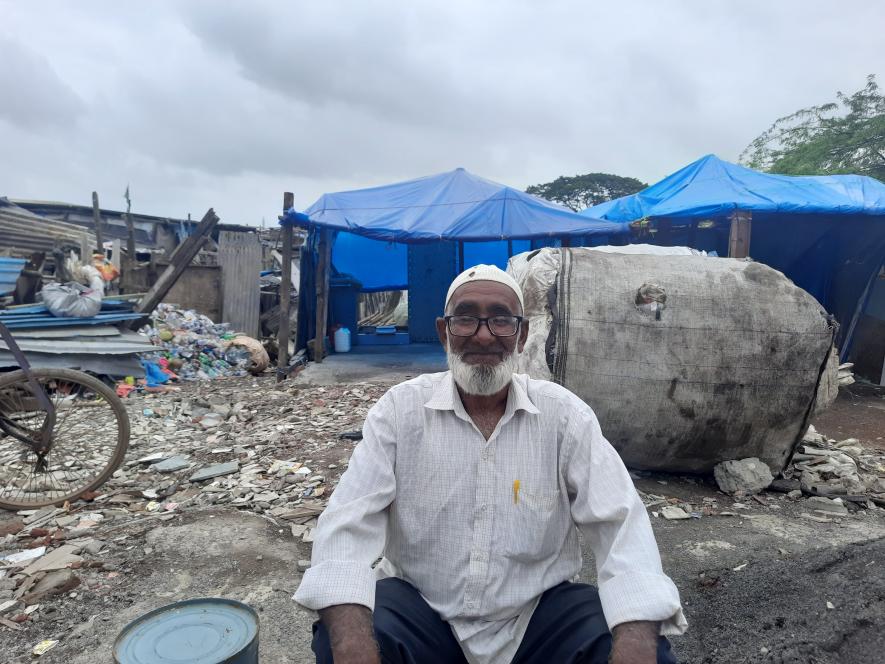 Rehman sitting outside the area where a few days back his house was. Now he stares at the happenings on the road wondering about his family's future.