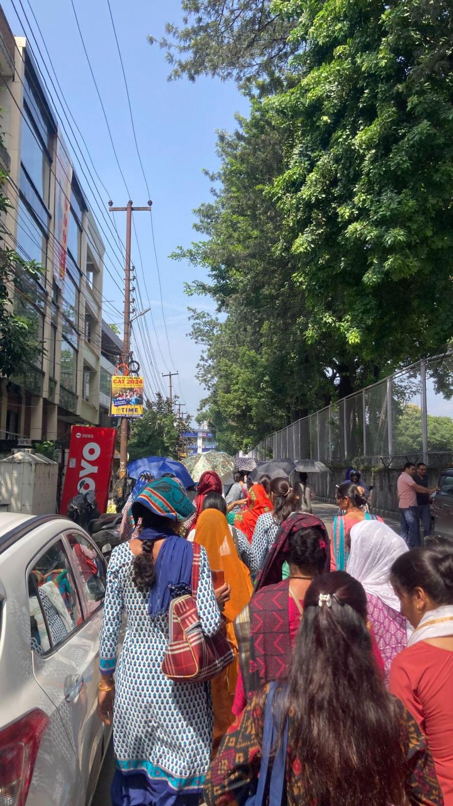 (Anganwadi workers marching through the streets of Dehradun)