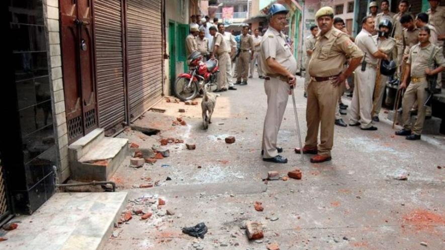 policemen standing in strret of riot-affected Muzaffarnagar in 2013