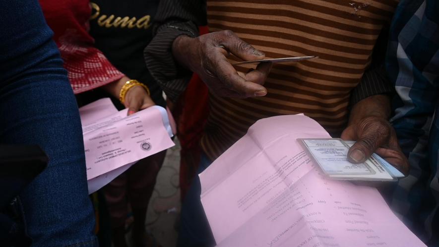 Residents with ID cards for Rehabilitation at Jailorwala Bagh Slum, Ashok Vihar, Delhi