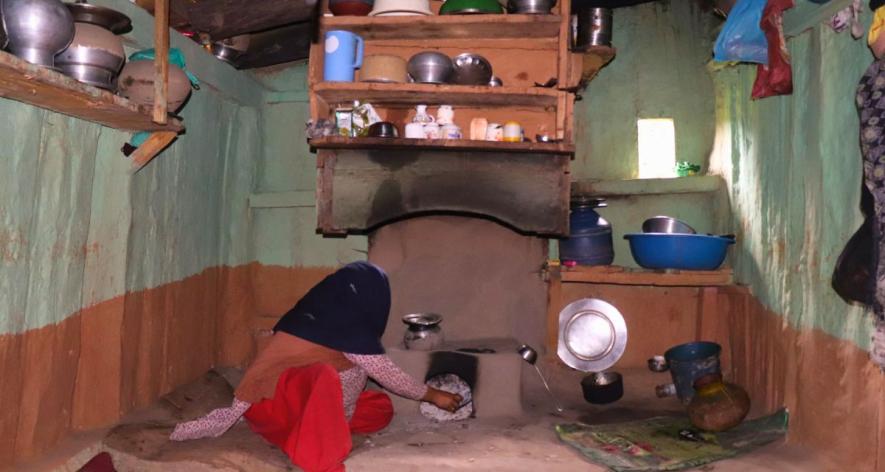 A woman using a traditional stove in the kitchen (Photo - Umer Farooq) (1).jpg