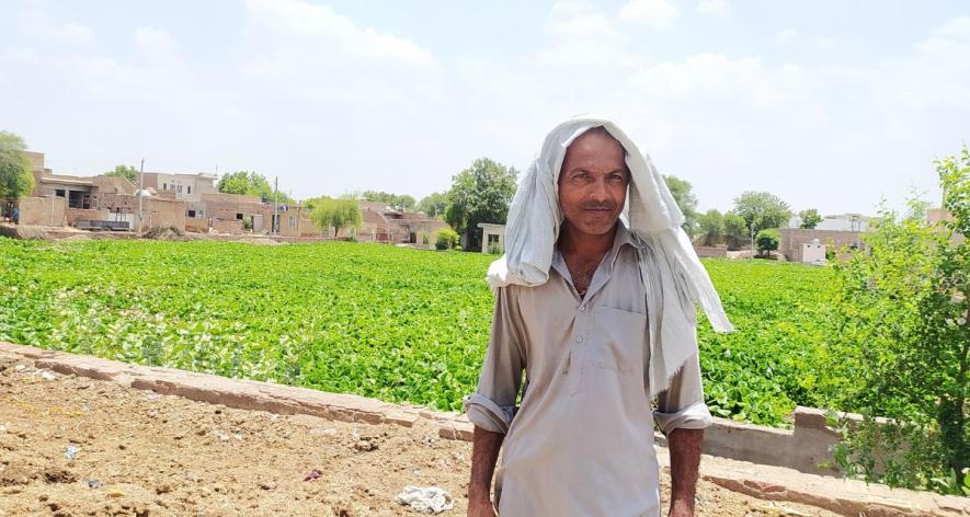 A villager showing a pond full of water hyacinth (Photo - Amarpal Singh Verma, 101Reporters)